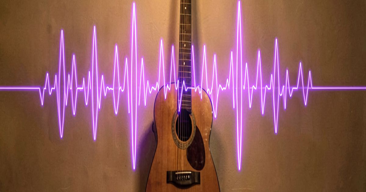 An acoustic guitar leaning against a studio wall with a glowing purple AI waveform overlay on a nearby monitor, warm golden lighting