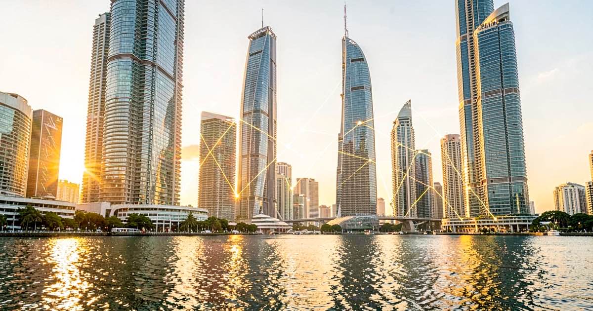 Bright warm morning scene of a modern Singapore waterfront skyscraper with warm golden sunlight reflecting off glass facades, a subtle digital network of glowing connections visible between buildings